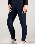 Person wearing navy leggings with text pattern and black long-sleeve top on a light gray background