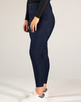 Navy riding pants worn by a person on a white background
